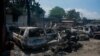FILE - Sisa-sisa kendaraan hangus yang dibakar di dekat garasi terlihat di Port-au-Prince, Haiti, pada 25 Maret 2024. PBB menggambarkan situasi di negara yang dilanda kekacauan itu sebagai 'bencana besar'.