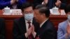 FILE - Chinese President Xi Jinping walks by then newly elected Chinese Foreign Minister Qin Gang during the closing ceremony for China's National People's Congress at the Great Hall of the People in Beijing, March 13, 2023.
