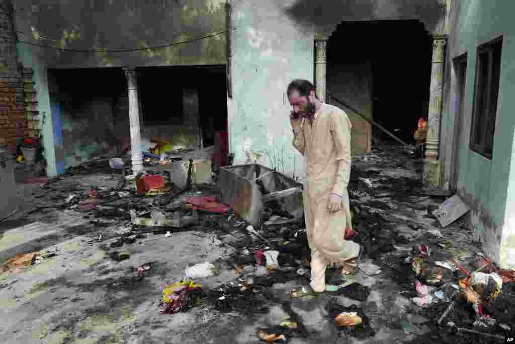 A Christian man checks a home vandalized by an angry Muslim mob in Pakistan on Aug. 17, 2023.