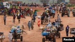 FILE - People fleeing the violence in West Darfur, cross the border into into Chad, Aug. 4, 2023.