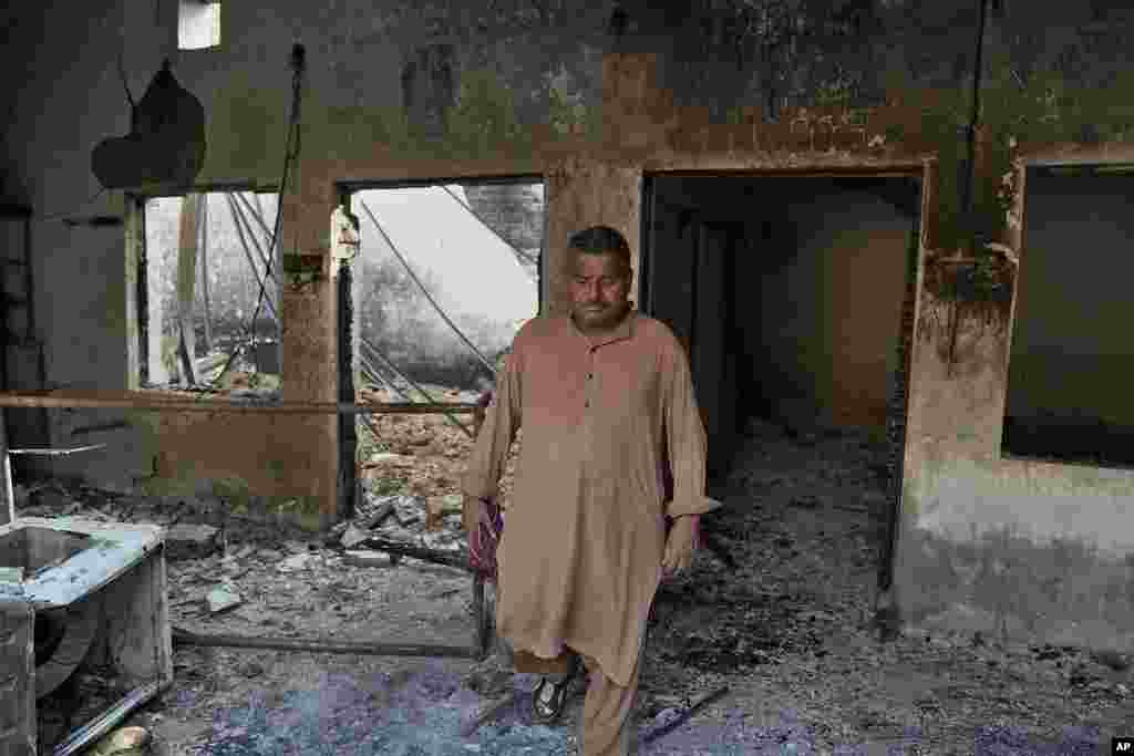 A Christian man checks a home vandalized by an angry Muslim mob in Pakistan on Aug. 17, 2023.