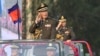 FILE - Cambodian Prime Minister Hun Sen salutes, along with his son Lt. Gen. Hun Manet, during an inspection of troops at a ceremony in Phnom Penh, Cambodia, Jan. 24, 2019. 