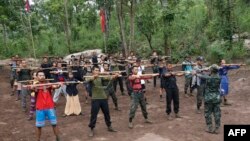 FILE - Members of the People's Defense Force, the armed wing of the civilian National Unity Government opposed to Myanmar's ruling military regime, take part in training at a camp in Kayin State, near the Myanmar-Thai border, Oct. 9, 2021.