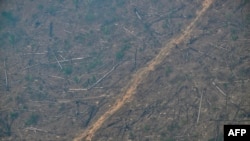FILE - Aerial image of an area of deforested Amazon rainforest covered in smoke from an illegal fire in the municipality of Cujubim, Rondonia State, northern Brazil, Aug. 20, 2024. Wildfires and drought ravaged large parts of the rainforest in 2024. 