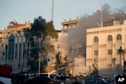 Emergency services work at a destroyed building hit by an air strike in Damascus, Syria, April 1, 2024. The airstrike, widely attributed to Israel, destroyed the consular section of Iran's embassy in Damascus, killing 12 people.