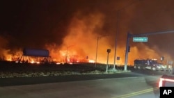 FILE - This photo provided by the County of Maui shows fire and smoke filling the sky from wildfires on Maui, an island in Hawaii, on Aug. 8, 2023. (Zeke Kalua/County of Maui via AP)