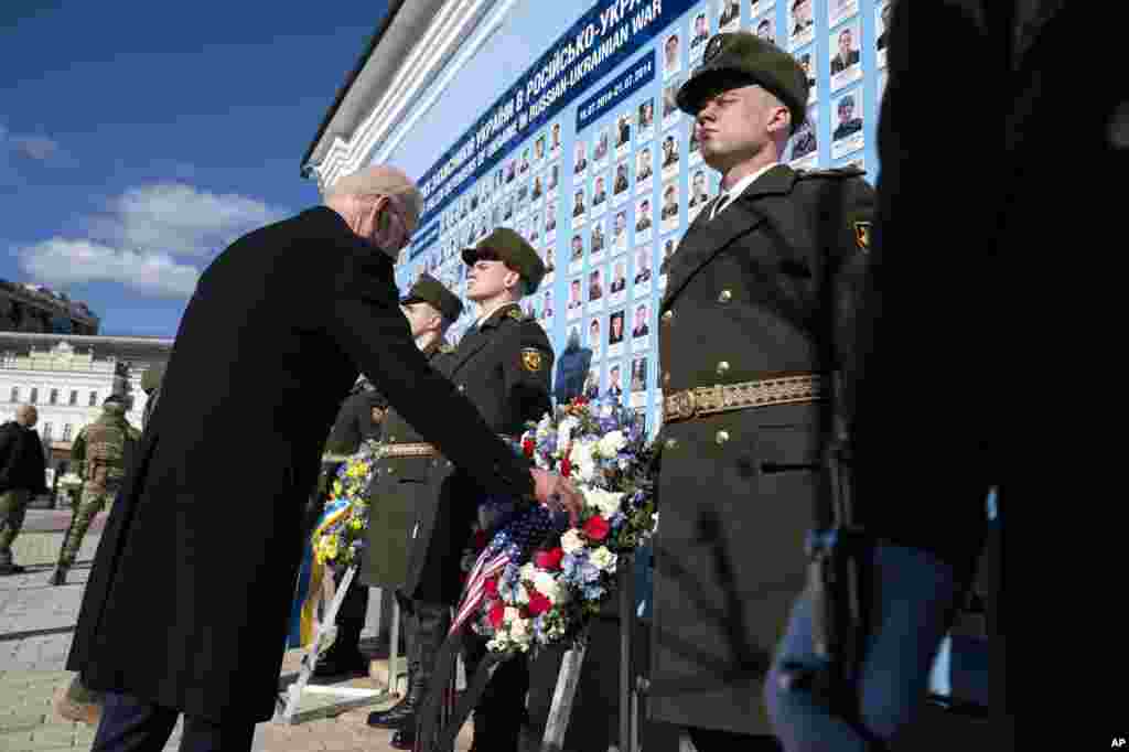 U.S. President Joe Biden participates in a wreath laying ceremony with Ukrainian President Volodymyr Zelenskyy at the memorial wall outside of St. Michael's Golden-Domed Cathedral in Kyiv, Feb. 20, 2023.
