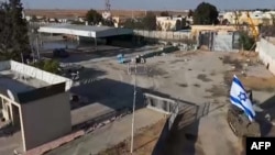 This image taken from footage released by the Israeli army shows an Israeli combat tank entering the Palestinian side of the Rafah border crossing between Gaza and Egypt, southern Gaza Strip, May 7, 2024, as part of Israel taking "operational control" of the crossing.