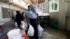 People receive charity ration sacks from the Saylani Welfare Trust's office, a non-government organization focusing primarily on feeding the poor and homeless, in Karachi, Pakistan, April 3, 2023.