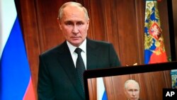 Russian President Vladimir Putin is seen on monitors as he addresses the nation. (Pavel Bednyakov, Sputnik, Kremlin Pool Photo via AP, File)