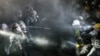 Cops face-off with pro-Palestinian students after destroying part of the encampment barricade on the campus of the University of California, Los Angeles (UCLA) in Los Angeles, California, May 2, 2024.
