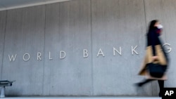 FILE - Signage is seen on the World Bank building in Washington, April 5, 2021.