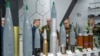 Belarusian military officers view heavy rounds on display at the Russian pavilion during the International Defense Exhibition (IDEX) at the Abu Dhabi International Exhibition Centre, Feb. 20, 2023. 