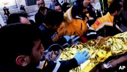 Rescue workers transport a man pulled from a collapsed building in Antakya, Turkey, Feb. 18, 2023.