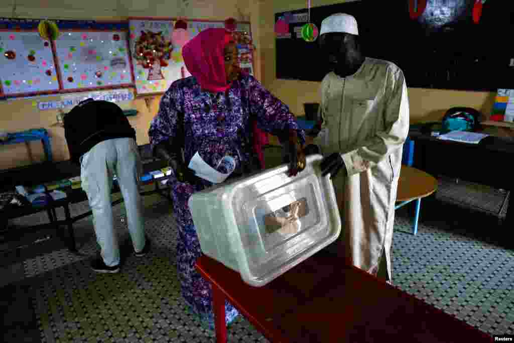 Electoral workers prepare the voting material during the presidential election at the polling station at Ecole HLM Grand Medine in Dakar, Senegal, March 24, 2024.