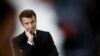 FILE - French President Emmanuel Macron gestures as he speaks with schoolchildren of the Jean Lartaut Middle School in Jarnac, western France, Feb. 28, 2023.