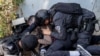 FILE — Israeli police and security forces assist a journalist taking cover during a rocket attack alert in Israel's southern city of Sderot near the border with Gaza, Oct. 12, 2023. At least 39 journalists have died while covering the Israel-Hamas war.