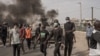 Protesters pushed parked cars onto streets to be used as roadblocks in Dakar, Senegal, March 16, 2023.