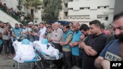 Mourners attend the funeral of fellow journalists Said al-Taweel and Mohammed Sobboh who were killed in an Israeli airstrike on Gaza City on Oct. 10, 2023. 