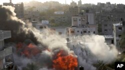 Smoke and fire rise from an explosion caused by an Israeli airstrike targeting a building in Gaza, May 13, 2023.