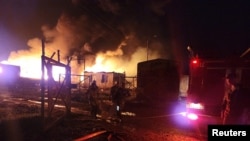 Rescue and medical personnel work following an explosion in the gasoline warehouse near the Stepanakert-Askera highway in Berkadzor, Nagorno-Karabakh in this handout picture released Sept. 25, 2023.