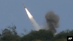 FILE — A U.S. M142 High Mobility Artillery Rocket System (HIMARS) fires a missile during a joint military exercise at a naval station in the Philippines, April 26, 2023. The U.S. is providing more military aid for Ukraine in a package that includes more rockets for HIMARS.