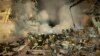 FILE - Emergency workers clear the rubble after a Russian rocket hit a building, leaving many people trapped under debris in the southeastern city of Dnipro, Ukraine, Jan. 14, 2023.