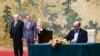Mussa Abu Marzuk, a senior member of Hamas, right, signs a document as China's Foreign Minister Wang Yi, second left, and Mahmoud al-Aloul, vice chairman of Fatah, look on at the Diaoyutai State Guesthouse in Beijing, July 23, 2024. 