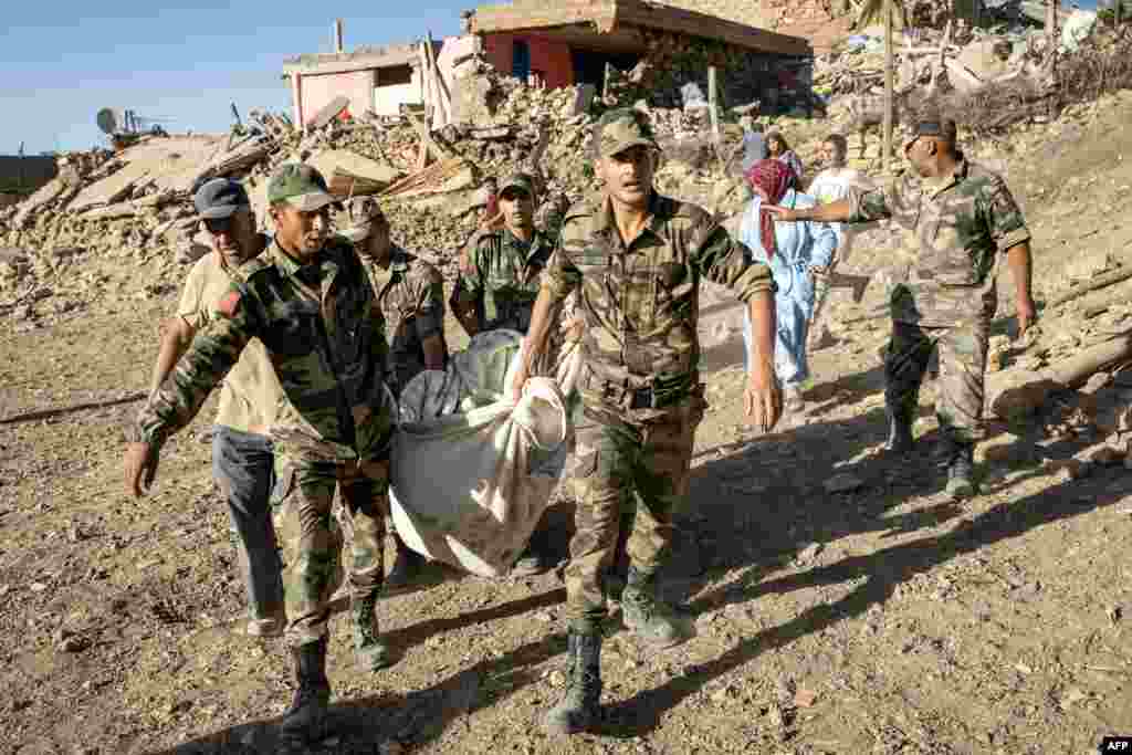 Moroccan Royal Armed Forces remove a body from a house destroyed in an earthquake in the mountain village of Tafeghaghte, southwest of the city of Marrakesh, Morocco, on Sept. 9, 2023.