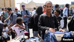 European, Asian and African nationals fleeing from the fighting in Sudan prepare to board a ship to Saudi Arabia, at Port Sudan, April 28, 2023.
