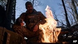 A Ukrainian soldier rests on the front line in Bakhmut, Donetsk region, Ukraine, March 22, 2023.