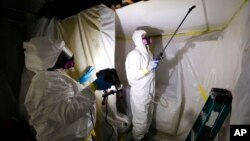 FILE - A crew works on asbestos abatement in Howell, Mich., Oct. 18, 2017. The Environmental Protection Agency on March 18, 2024, announced a ban on asbestos, a carcinogen that is still used in some chlorine bleach, brake pads and other products.