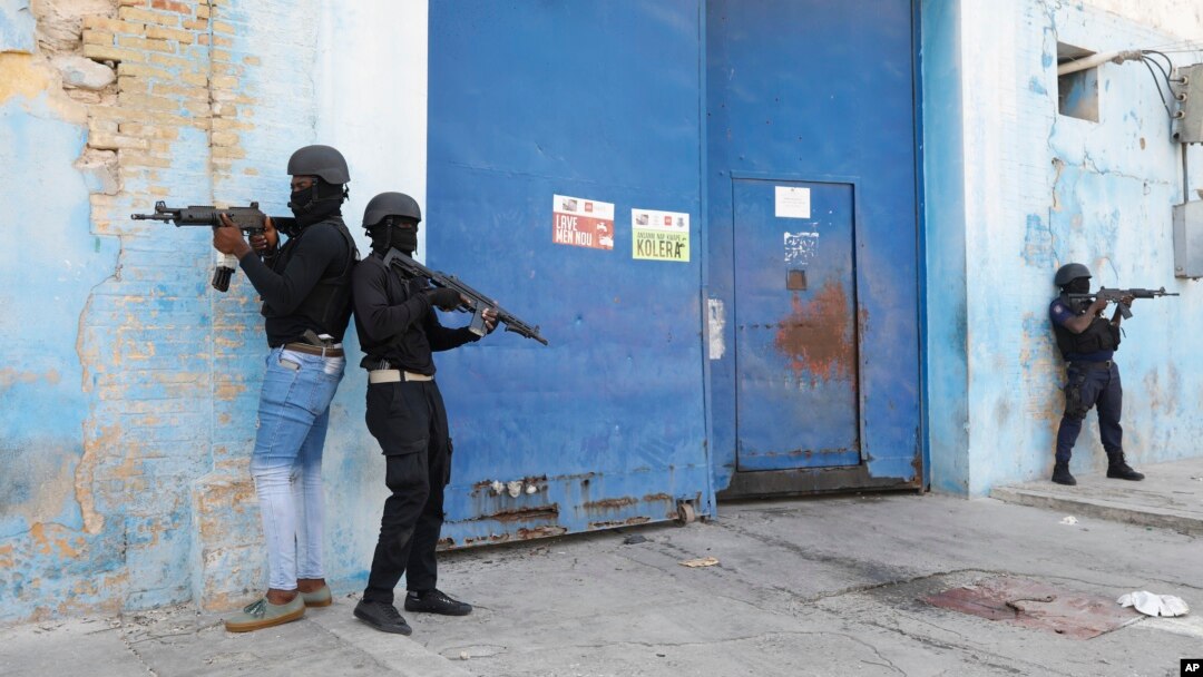 Polis nasyonal Ayiti (PNH) veye Penitansye Nasyonal la ki vid kounyea, apre dife pete andedan enstalasyon an, anbalavil Potoprens, 14 Mas, 2024. 