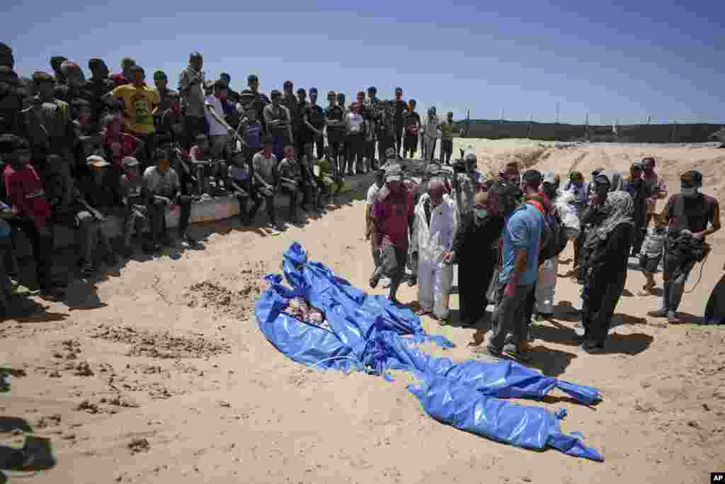 Workers bury bodies returned by Israel in a cemetery in Khan Younis, Gaza Strip. A Palestinian official says Israel has returned more than 80 bodies to the Gaza Strip. The identities of the deceased and the cause of death were not immediately known. 
