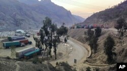 Stranded trucks loaded with supplies for Afghanistan park in a terminal alongside on a highway on Feb. 21, 2023, after Afghan Taliban rulers closed a key border crossing point Torkham, in Pakistan's district Khyber along the Afghan border.