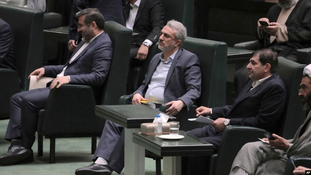 Iranian Industries Minister Reza Fatemi Amin, center, listens during a session of parliament debating his impeachment, in Tehran, Iran, April 30, 2023.