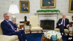 FILE - Speaker of the House Kevin McCarthy of Calif., left, listens as President Joe Biden speaks about the debt limit in the Oval Office, May 9, 2023, in Washington.