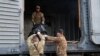 Members of a Ukrainian Civil-Military Cooperation team load the remains of a Russian soldier into a railroad car in the village of Synykha, in Ukraine's Kharkiv region, April 8, 2023, amid Russia's invasion of its neighbor.