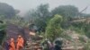 Tim SAR mencari korban di lokasi tanah longsor yang melanda sebuah desa di Pulau Serasan, Kabupaten Natuna, Senin, 6 Maret 2023. (BNPB via AP)