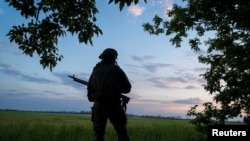 A Ukrainian serviceman of the 92nd separate assault brigade guards an area near the town of Vovchansk in Kharkiv region, Ukraine, May 19, 2024.