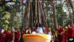 FILE - Ram Bahadur Bamjan, center in white, is surrounded by Buddhist monks in Nijgadh town, south of Katmandu, Nepal, Nov. 12, 2008. 