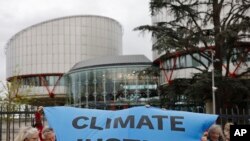 People demonstrate outside the European Court of Human Rights, Apr. 9, 2024 in Strasbourg, eastern France.