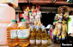 FILE - An oil vendor reacts at the Mvog Ada market in Yaounde, Cameroon, Jan. 29, 2022.