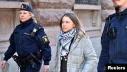 Petugas polisi menahan aktivis iklim Greta Thunberg selama aksi iklim di luar parlemen Swedia Riksdagen, di Stockholm, Swedia, 12 Maret 2024. (Kantor Berita TT/Samuel Steen/via REUTERS)