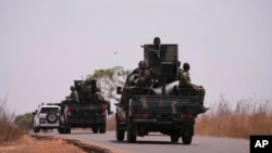 The Nigerian army patrols near a primary and secondary school where students were kidnapped, in Kuriga, Kaduna state, Nigeria, March 9, 2024. In additional attacks in the region March 16 and 17, gunmen reportedly kidnapped more than 100 people. 