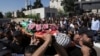 Mourners carry the body of Qusai Matan, 19, during his funeral in the West Bank city of Ramallah, Aug. 5, 2023. 