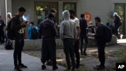 People from all over the world line up in front of the central registration center for asylum seekers in Berlin, Germany, Sept. 25, 2023.