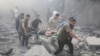 FILE - Palestinians evacuate wounded after an Israeli airstrike in Rafah refugee camp, southern Gaza Strip, Oct. 12, 2023.