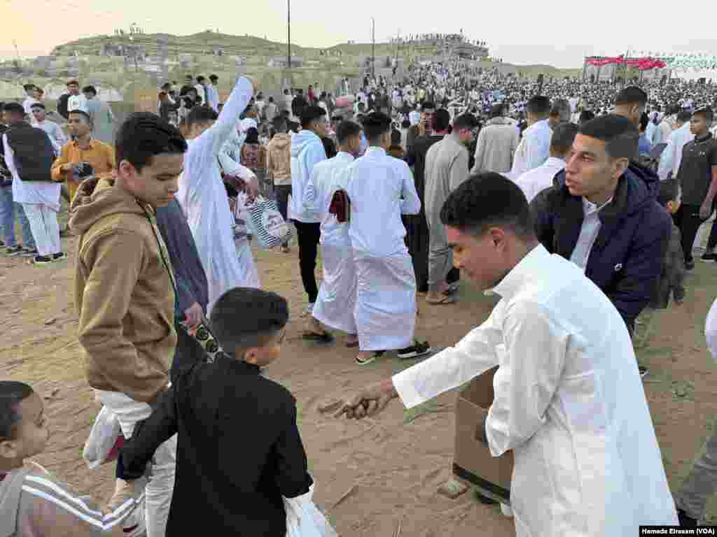Brothers Mahmoud and Abdullah distribute dates among worshippers young and old. “We try to spread happiness to people,” says Mahmoud, “and we wish that Palestinians will have time to celebrate Eid, too.” Abusir, Egypt, April 10, 2024.