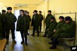 FILE - Recruits gather to get their uniforms at a regional military recruitment center in Rostov-on-Don, Russia, Oct. 31, 2022.
